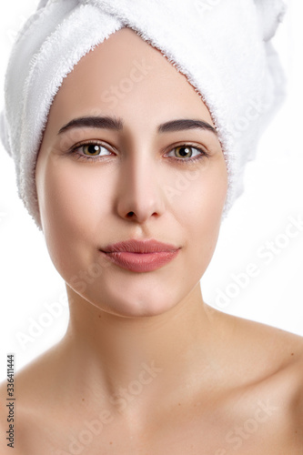 Girl with towel on head on white background,with clear skin