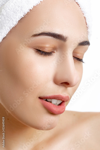 Girl with towel on head on white background,with clear skin