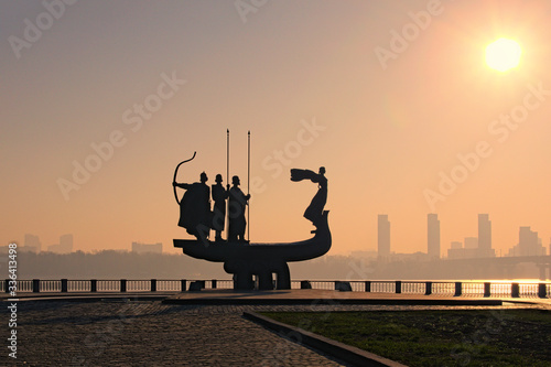 Black silhouette of famous Monument to legendary founders of Kyiv: Kiy, Schek, Khoryv and their sister Lybid on Dnieper river coast. Haze in the morning during sunrise. Kyiv, Ukraine photo