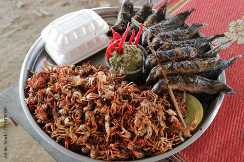 Plate of grilled crabs and fishes sold in a cambodian food market