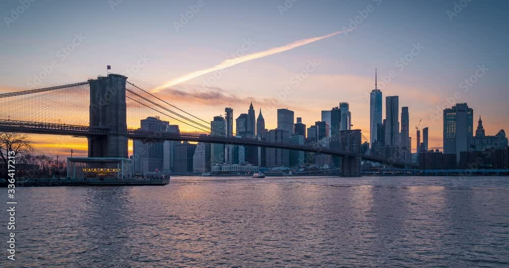 Panoramic Sunset View of Brooklyn bridge downtown Manhattan and one world seen from BUMBO day to night time lapse. New York city, NY, USA. Panoramic Sunset View of Brooklyn bridge downtown Manhattan and one world seen from BUMBO day to night time lapse. New York city, NY, USA.