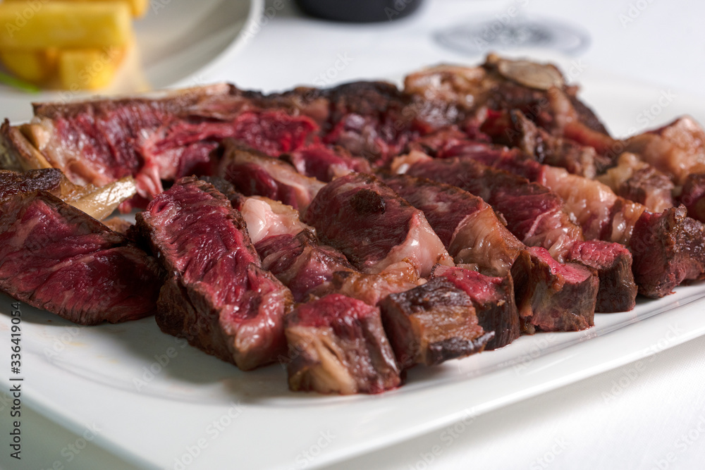 Medium, medium rare grilled steak in a plate. Grilled steak.