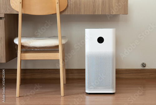 Indoor air purifier with digital monitor screen in bedroom, that show air quality in the room and air pollution levels in the room. PM 2.5 is a major environmental health problem affecting everyone.