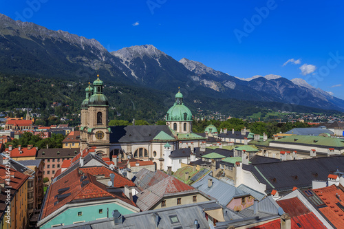 Bright and colorful eagle eye photo of the city center and its buildings of the Austrian Tirol city of Innsbruck, guided by its background alps.