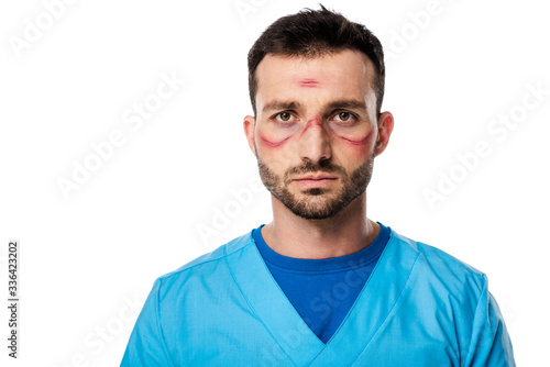 tired doctor with marks on face isolated on white