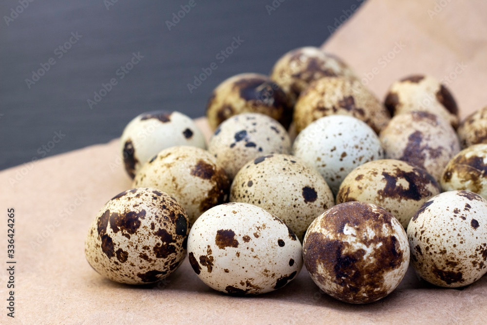 quail eggs on craft paper on a dark background.