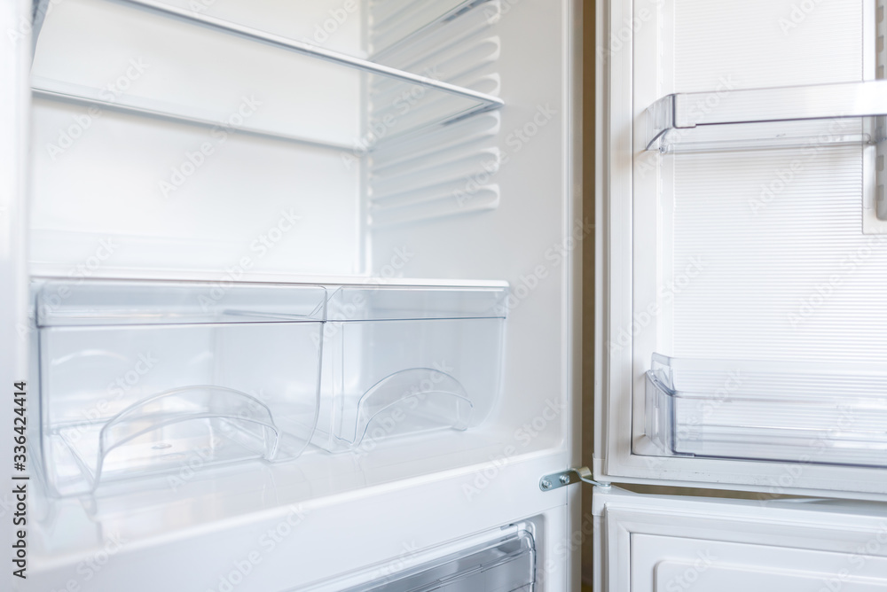 Empty shelves in refrigerator. The concept of diet and hunger Empty shelves in refrigerator. The concept of diet and hunger