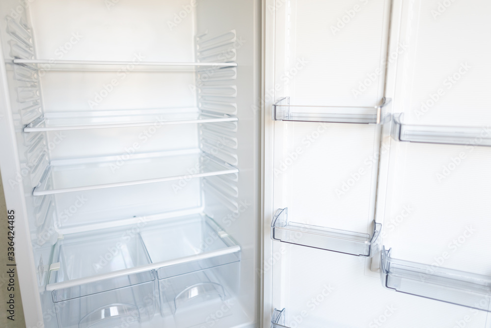 Empty shelves in refrigerator. The concept of diet and hunger Empty shelves in refrigerator. The concept of diet and hunger