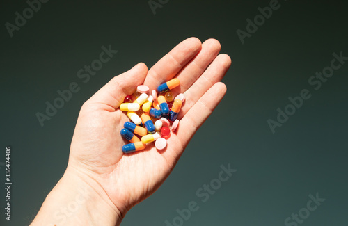 Colorful pills and medicines in the hand.