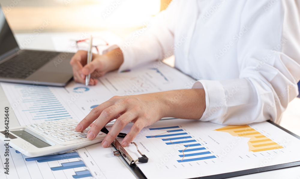 Accounting businessmen are calculating income-expenditure and analyzing real estate investment data, Financial and tax systems concept. Accounting businessmen are calculating income-expenditure and analyzing real estate investment data, Financial and tax systems concept.