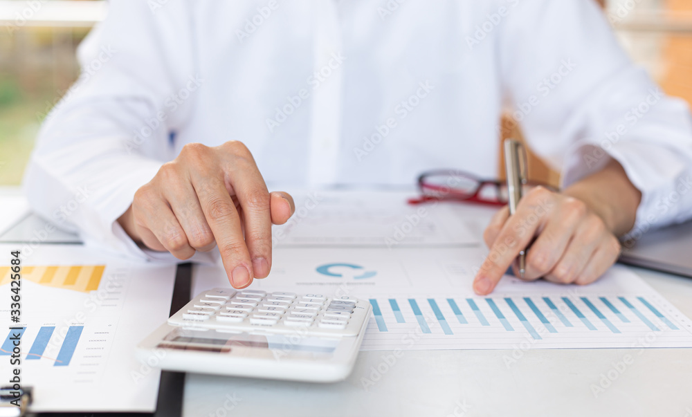 Accounting businessmen are calculating income-expenditure and analyzing real estate investment data, Financial and tax systems concept. Accounting businessmen are calculating income-expenditure and analyzing real estate investment data, Financial and tax systems concept.