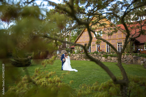 Wallpaper Mural Beautiful wedding couple posing in the garden near barn Torontodigital.ca