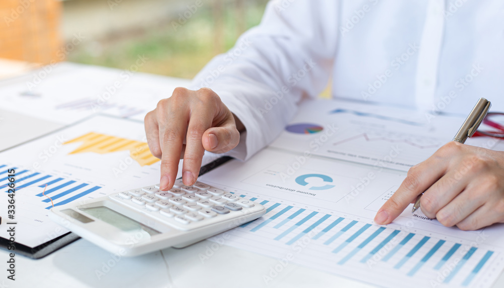 Accounting businessmen are calculating income-expenditure and analyzing real estate investment data, Financial and tax systems concept. Accounting businessmen are calculating income-expenditure and analyzing real estate investment data, Financial and tax systems concept.