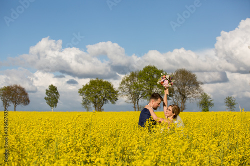 Beautiful young wedding couple posing outdoor in yellow field © hreniuca