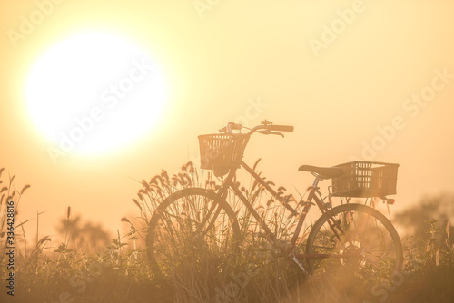 beautiful landscape image with bicycle at sunset ; vintage filter style © AlexPhototest