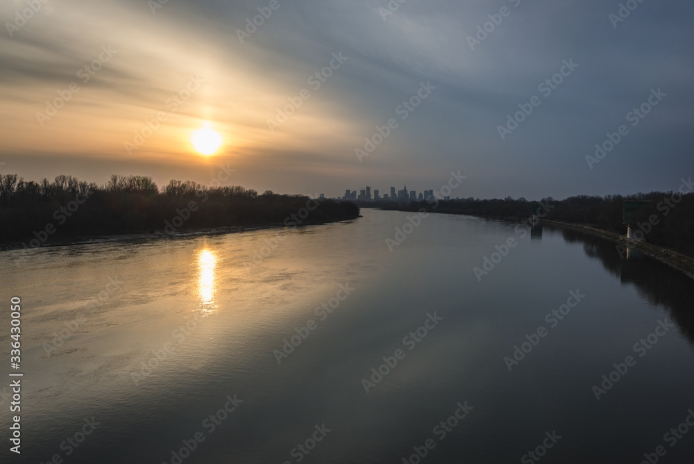 Sunset over River Vistula and distance view of downtown in Warsaw, Poland