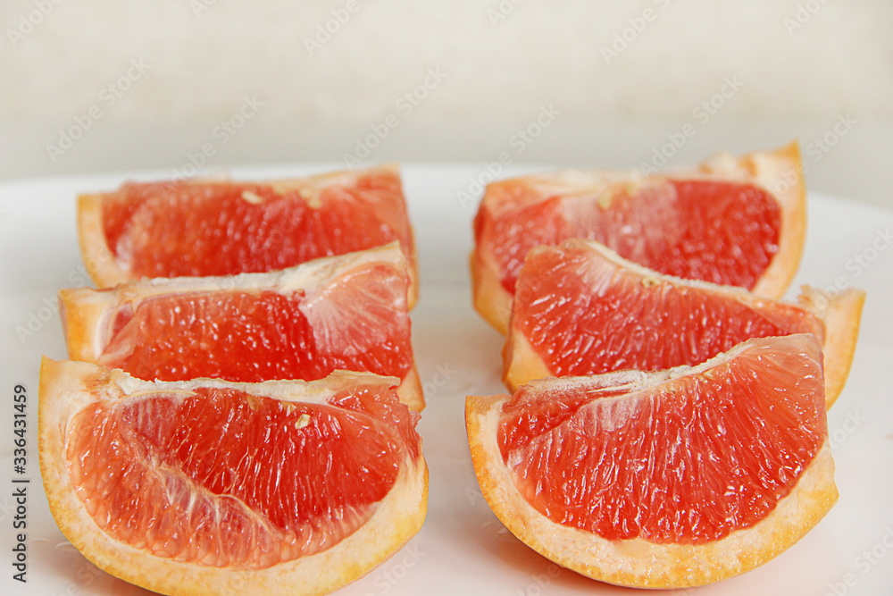 slices of red grapefruit close up on a white background slices of red grapefruit close up on a white background