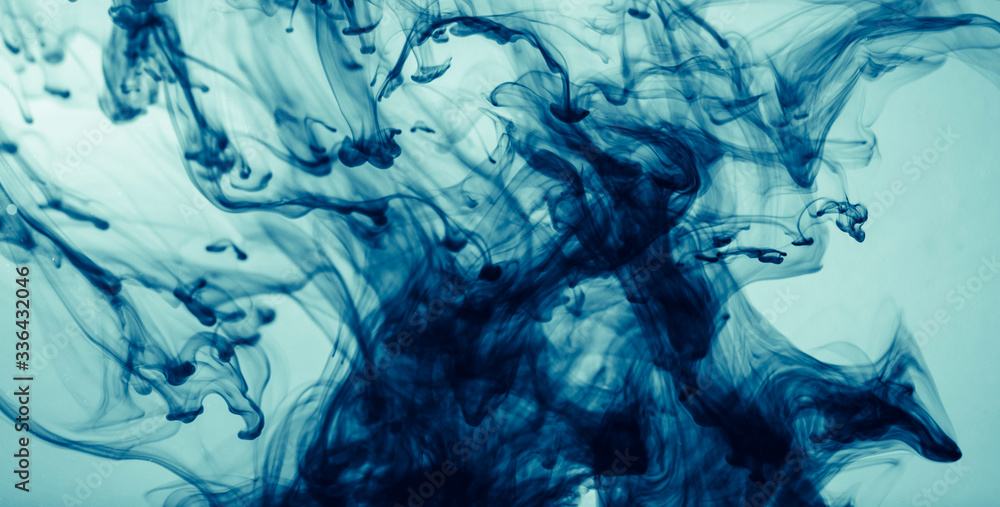 Abstract color paint splash on blue background. Modern design with motion liquid dye. Abstract color paint splash on blue background. Modern design with motion liquid dye.