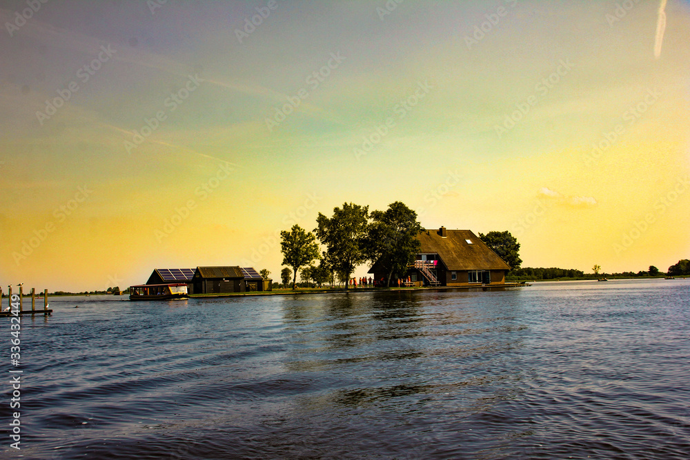 Houses in the middle of the lake during the sunset and with lots of color