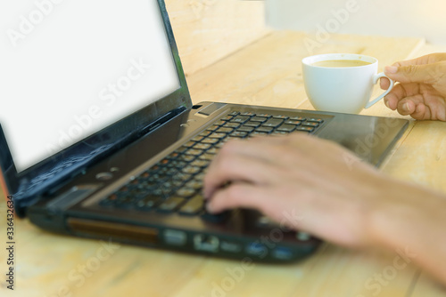 Work from home / The man use laptop and have a cup of hot coffee in working time