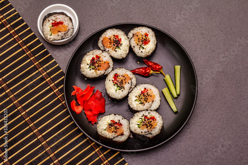 Korean roll Gimbap(kimbob). Steamed white rice (bap) and various other ingredients. Trendy black background