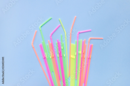 Colourful plastic straws on blue background. Cocktail tubes. Place for your text. Say no plastics. Plastic free concept.