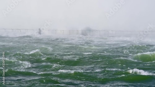 Hurricane and severe flood, waves hitting bridge near coast photo