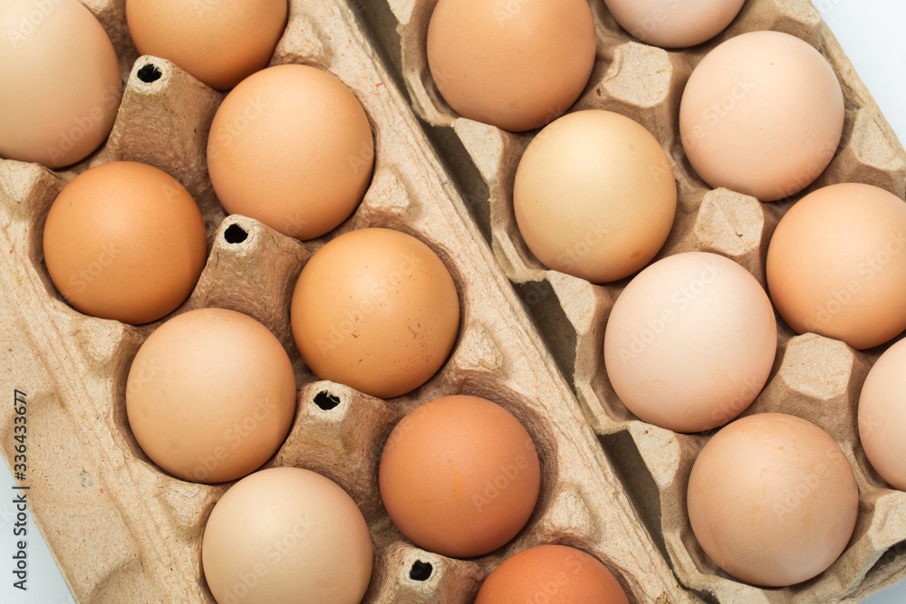  chicken eggs in an open cardboard box with eggs. Fresh chicken eggs background. close-up