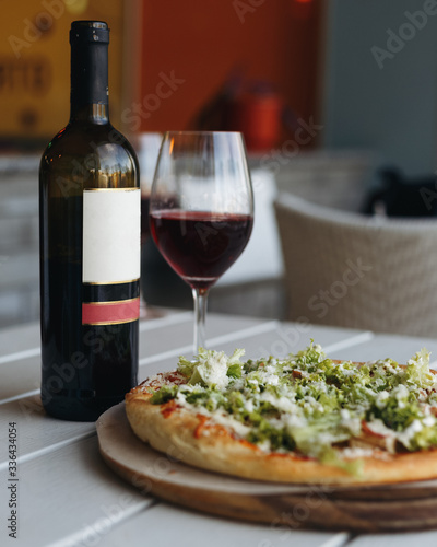 Bottle of red wine and pizza