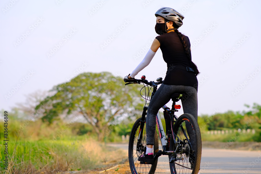 sporty woman riding a mountain bike in the natural background