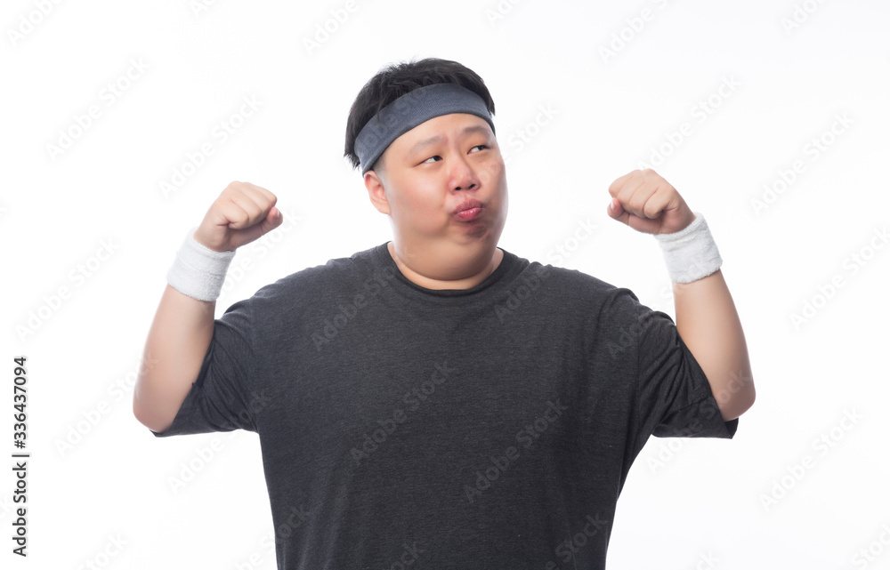 Asian funny fat man in sport outfits showing strenght and looking to copyspace isolated on white background. Asian funny fat man in sport outfits showing strenght and looking to copyspace isolated on white background.