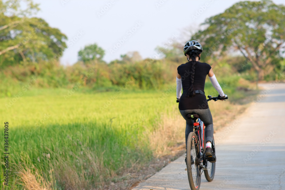 sporty woman riding a mountain bike in the natural background sporty woman riding a mountain bike in the natural background