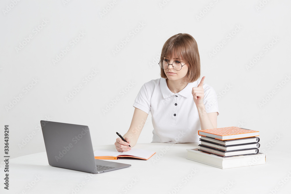 Cool happy girl goes through online training sitting at home. Remote school education on a laptop. Stay home lessons. Cool happy girl goes through online training sitting at home. Remote school education on a laptop. Stay home lessons.