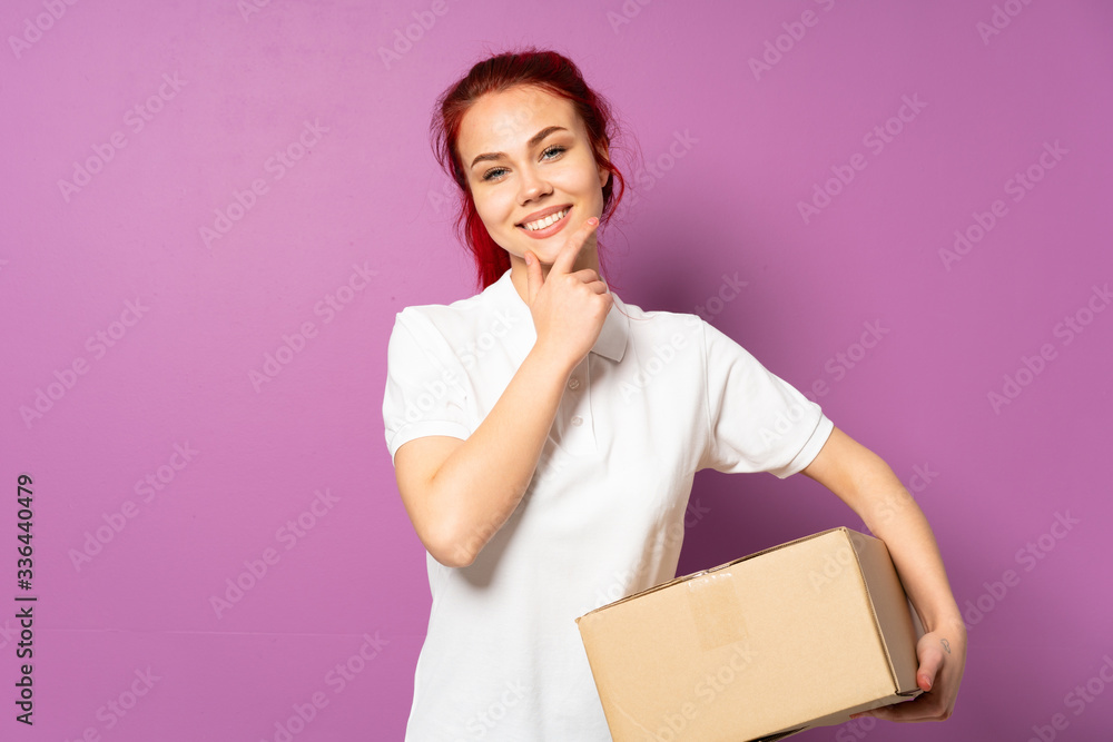 Teenager delivery girl isolated on purple background happy and smiling Teenager delivery girl isolated on purple background happy and smiling