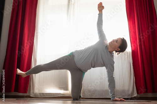 Peaceful sporty woman practicing yoga side plank or vasishtasana photo