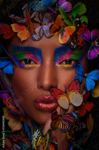 beautiful african girl surrounded by butterflies