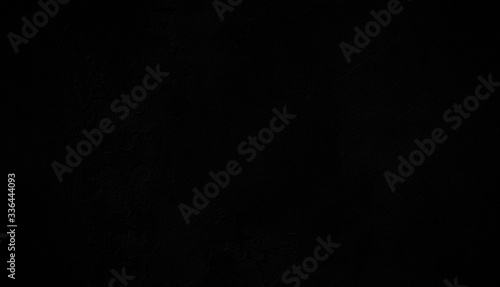 Fotografie Close-up of a dark weathered and old concrete wall, paint is peeling off