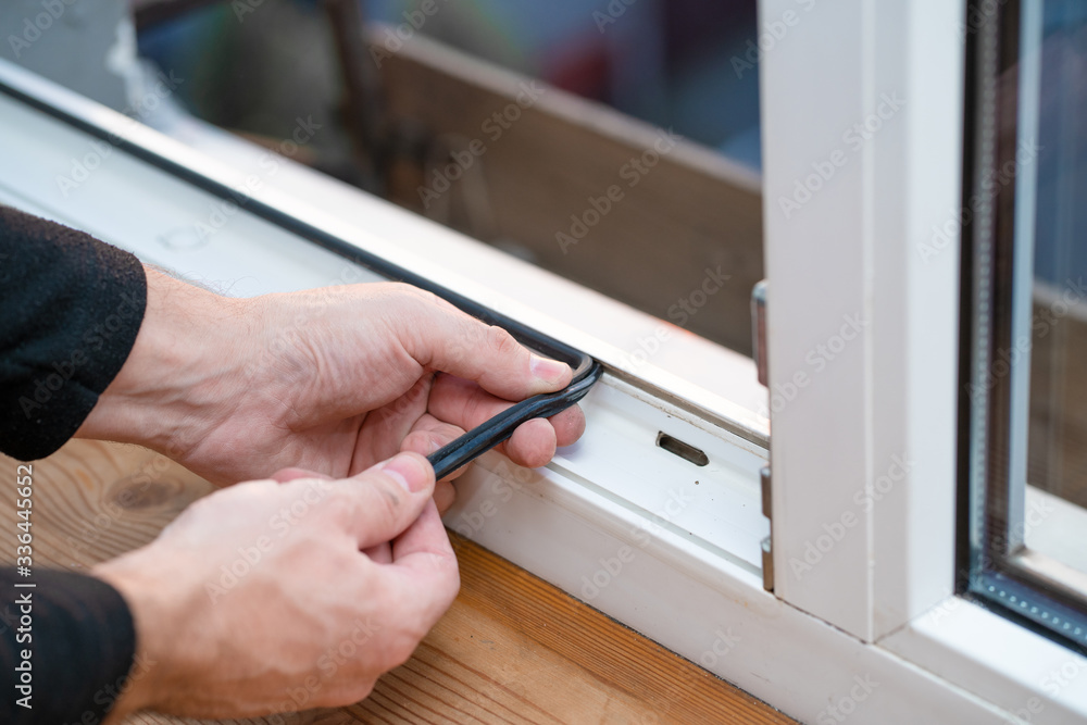 Professional master at repair and installation of windows, changes rubber seal gasket in pvc windows