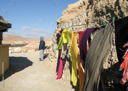 Man and hanged clothes in the desert