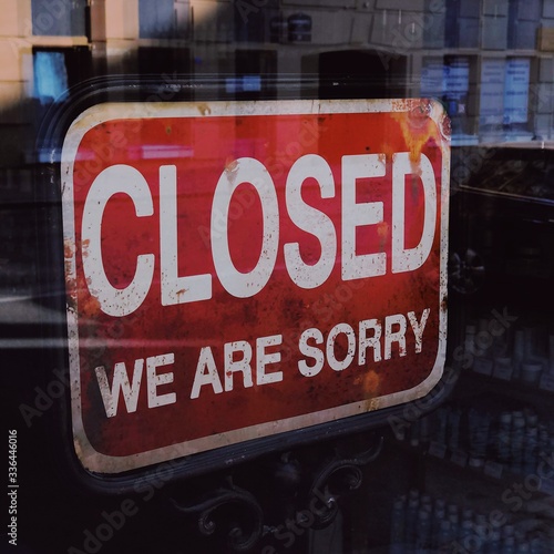 "Closed We are Sorry" message board on a shop window, abandoned closed shut down cafe restaurant business, Coronavirus COVID-19 disease global pandemic outbreak, isolation quarantine lockdown concept