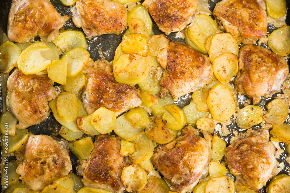 Roasted chicken meat with potatoes on a brow top view. Home lunch Roasted chicken meat with potatoes on a brow top view. Home lunch