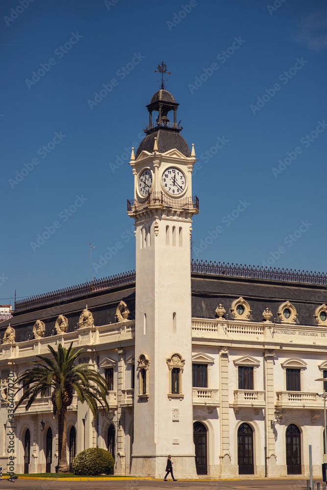 woman infront the clock tower in valencia