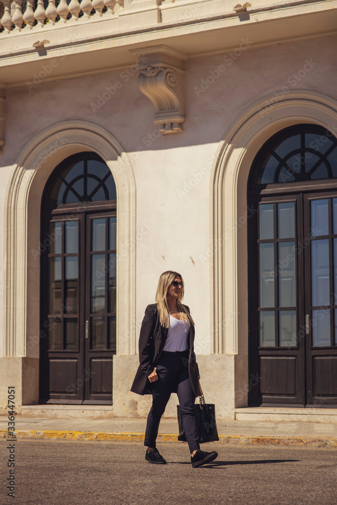 young woman standing in front of a building young woman standing in front of a building