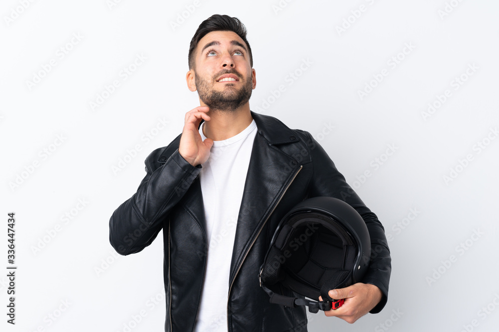 Man with a motorcycle helmet thinking an idea Man with a motorcycle helmet thinking an idea