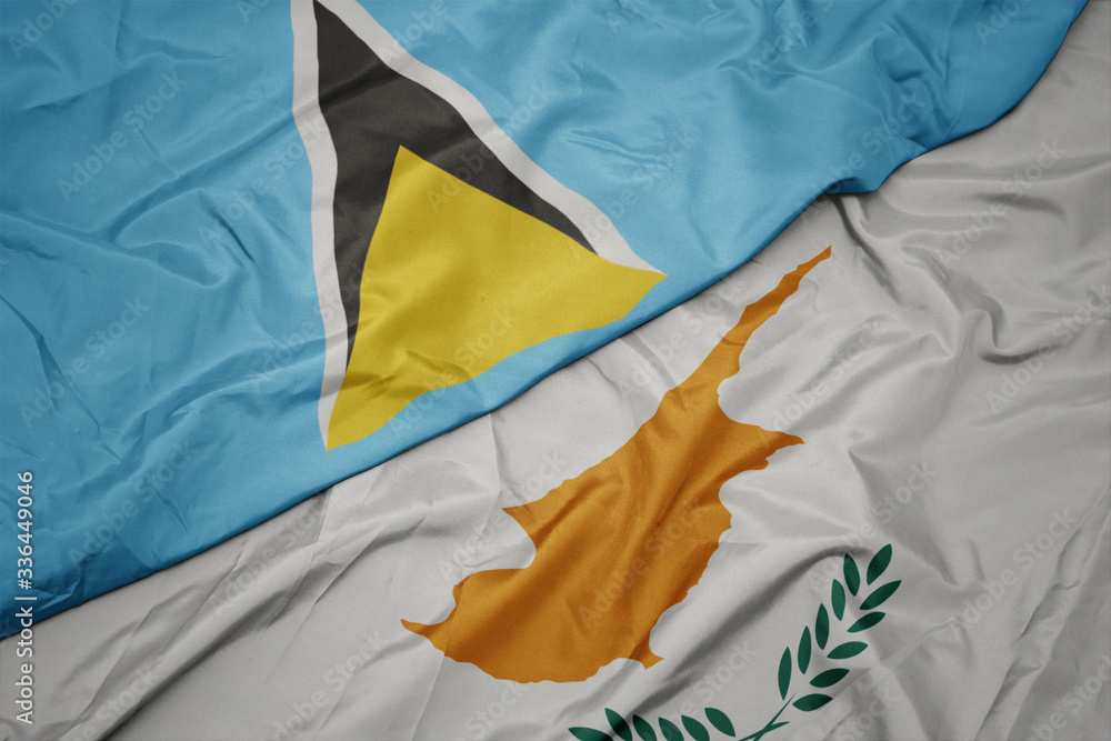 waving colorful flag of cyprus and national flag of saint lucia.