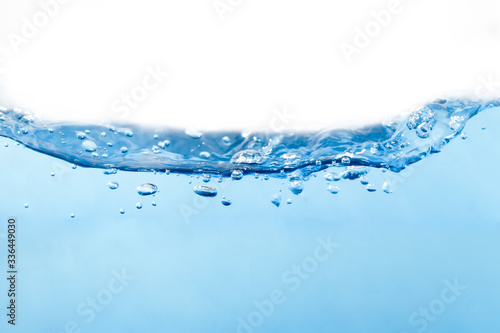 The water wave, The water surface is clean, blue in color, underwater with small bubbles and a white background..
