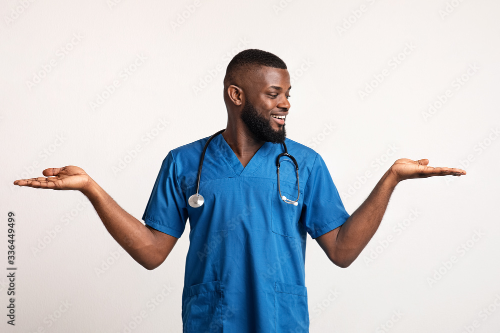Excited african doctor holding something invisible on his hands