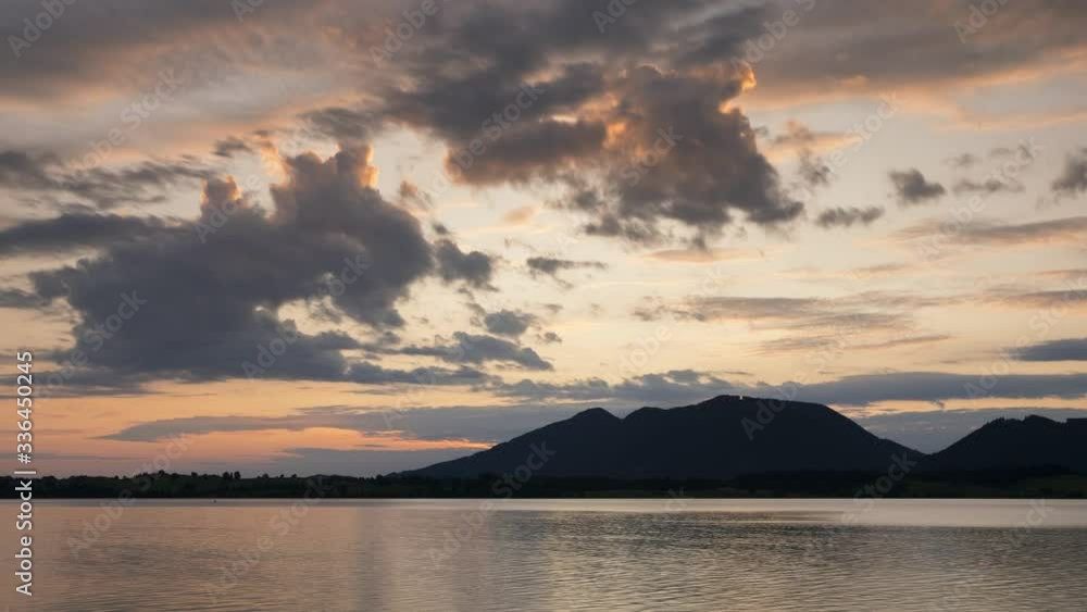 Time lapse of sunrise over lake Forggensee with mountains of Allgaeu in background, colourful moving clouds, Fuessen Bavaria
Time lapse of sunrise over lake Forggensee with mountains of Allgaeu in background, colourful moving clouds, Fuessen Bavaria