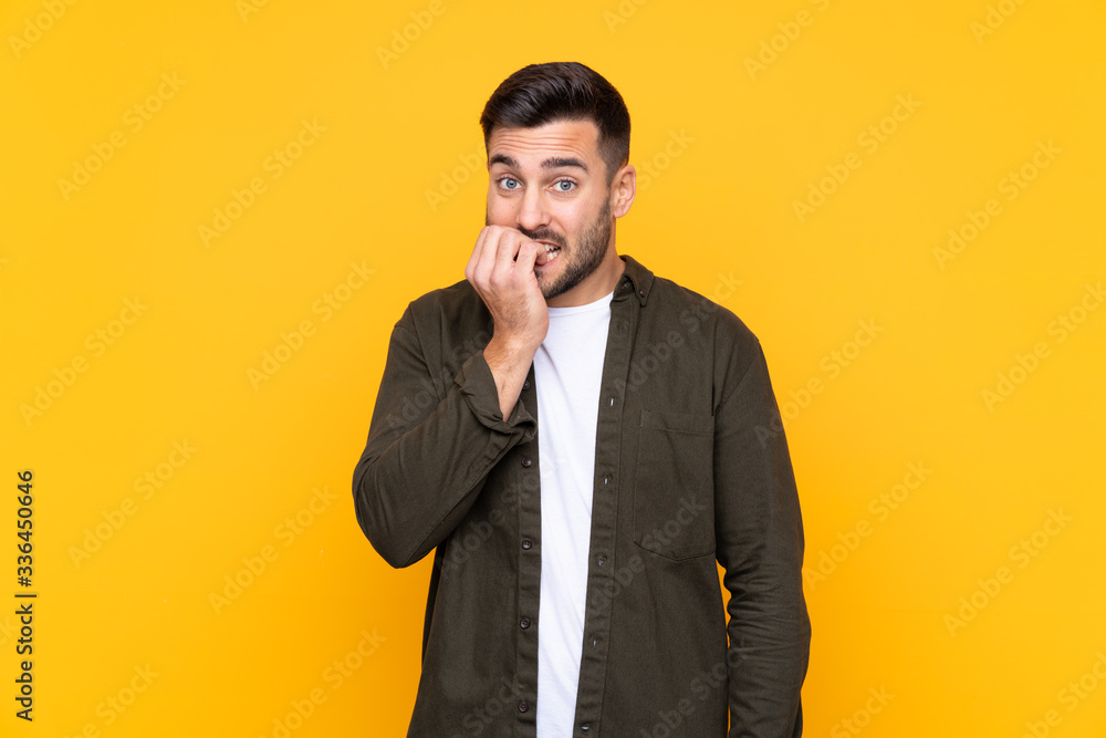 Man over isolated yellow background nervous and scared Man over isolated yellow background nervous and scared