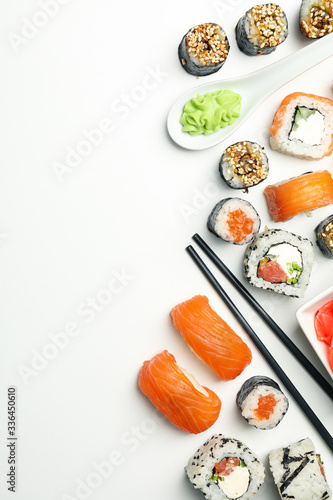 Sushi rolls and chopsticks on white background, space for text. Japanese food